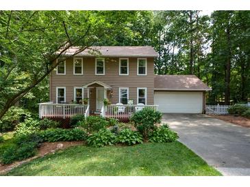 Two-story house with deck, attached garage, and landscaped yard at 4848 Green Forest Nw Ct, Acworth, GA 30102