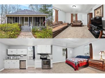 Charming home featuring a cozy, screened-in front porch and lush landscaping at 204 Morris St, Palmetto, GA 30268