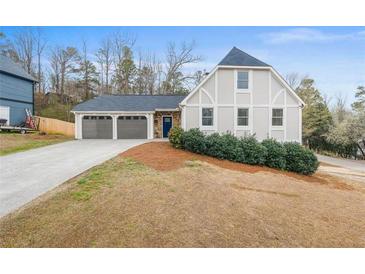 Charming house with a two-car garage and well-manicured lawn at 326 Scarlett Ln, Woodstock, GA 30188