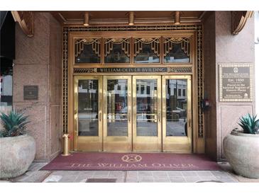 Grand building entrance with ornate bronze doors and details at 32 Peachtree Nw St # 1601, Atlanta, GA 30303