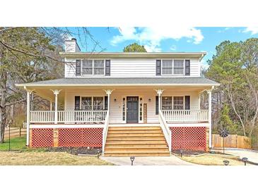 Charming two-story home with inviting front porch and well-maintained lawn at 1867 Falcon Wood Ne Dr, Marietta, GA 30066