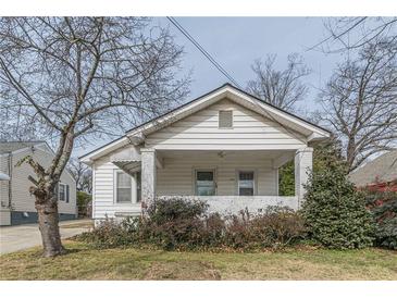 Charming white house with covered porch and well-maintained lawn at 523 North Ave, Hapeville, GA 30354