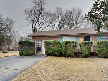 Charming brick home with a well-manicured front yard and covered entry at 1581 Wesley Nw Way, Conyers, GA 30012