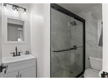 Modern bathroom with a large glass shower and white vanity at 300 Peachtree St # 24-I, Atlanta, GA 30305