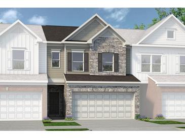 Two-story townhome with stone accents and a two-car garage at 20 Jacobs Farm Ln # 10, Lawrenceville, GA 30043