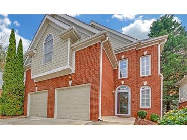 Charming brick home with a two-car garage and manicured landscaping at 1125 Blackshear Dr, Decatur, GA 30033