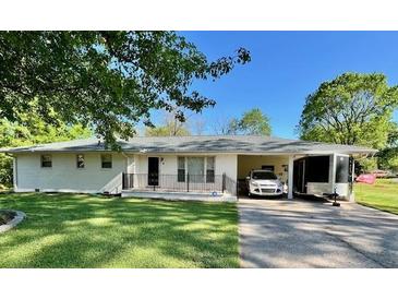 Charming single-story home featuring a well-manicured lawn, covered parking, and brick accents at 4 Crestwood Rd, Cartersville, GA 30121