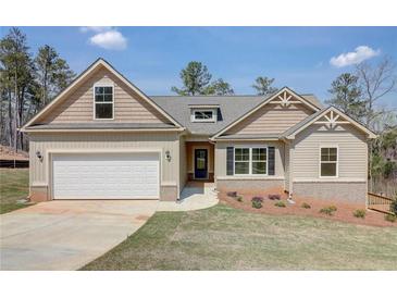 New single-story home with a two-car garage, landscaping, and a light beige exterior at 215 Eryn Ter, Covington, GA 30014