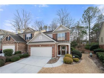 Charming brick townhome with attached garage, landscaped yard, and inviting entrance in a desirable neighborhood at 5800 Oakdale Se Rd # 165, Mableton, GA 30126