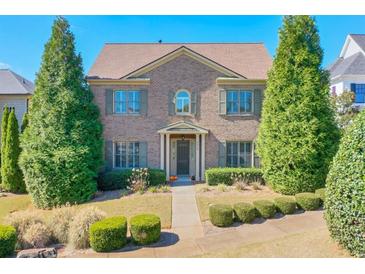 Brick two-story house with landscaping and walkway at 2005 Heathermere Way, Roswell, GA 30075