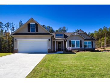 Two-story craftsman style home with attached garage and manicured lawn at 130 Eryn Ter, Covington, GA 30014