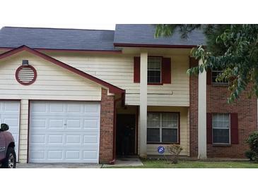 Two-story house with a two-car garage and a well-maintained lawn at 1969 Corners Cir, Lithonia, GA 30058