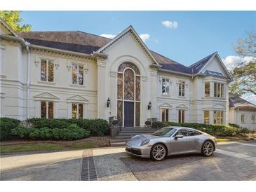 Elegant two-story home with grand entrance and manicured landscaping at 70 Finch Forest Trl, Atlanta, GA 30327