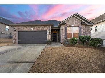 Brick house with a two-car garage and manicured lawn at 554 Lance View Ln, Lawrenceville, GA 30045