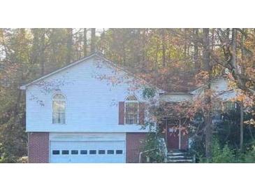 Two-story house with attached garage and wooded backdrop at 223 Old Alabama Rd, Emerson, GA 30137