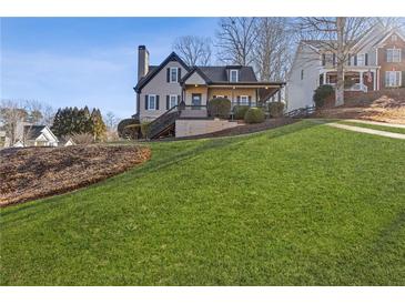 Two-story house with a large front porch and landscaped yard at 610 Lovinggood Trl, Woodstock, GA 30189