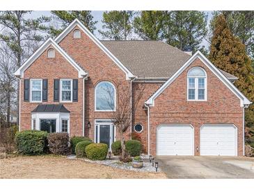 Charming brick two-story home featuring a well-manicured front yard and attached two-car garage at 2107 Kendall Close Nw, Acworth, GA 30102