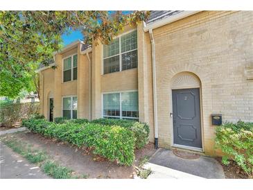 Inviting brick front exterior of townhome with landscaping and private entrance at 5400 Roswell Rd # E2, Atlanta, GA 30342