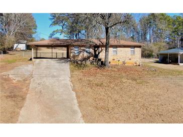 Brick ranch home with carport and long driveway at 5052 Central Church Rd, Douglasville, GA 30135