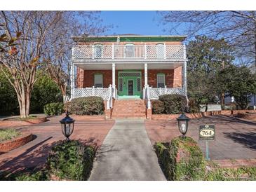 Brick two-story home with white porch and landscaping at 764 Edgewood Ne Ave # 8, Atlanta, GA 30307