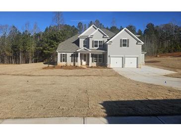 Two story home with three car garage and large front yard at 3292 Lions Ruby Ln, Atlanta, GA 30349