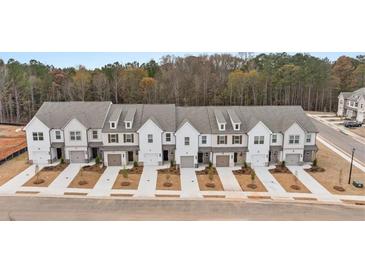 Aerial view of new townhome community with attached garages and landscaping at 261 Kenoot Dr # 41, Mcdonough, GA 30253