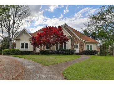 Beautiful two-story house with stone accents and a red maple tree at 3060 Cabernet Ct, Cumming, GA 30041