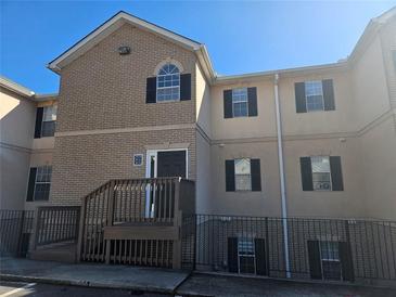 Brick townhouse exterior with stairs and a small patio at 3974 Stillwater Dr, Duluth, GA 30096