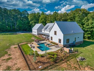 Luxury farmhouse with pool & detached garage; expansive lawn & wooded setting at 2731 Tribble Mill Rd, Lawrenceville, GA 30045