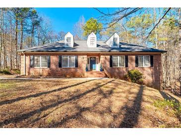 Brick house with a two-car garage and landscaped yard at 796 Marion Beavers Rd, Sharpsburg, GA 30277