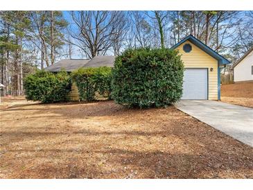 Ranch style house with attached garage and mature shrubs at 226 Old Atlanta Rd, Stockbridge, GA 30281