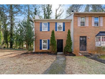 Charming brick townhome with blue shutters and manicured landscaping at 2777 Northwood Sw Ct, Marietta, GA 30060