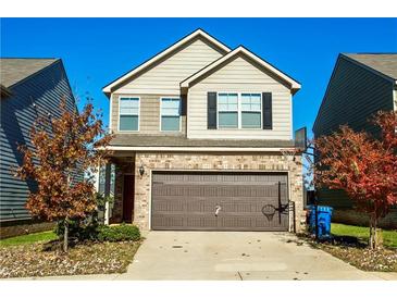Two-story house with a two-car garage and basketball hoop at 264 Magnaview Dr, Mcdonough, GA 30253