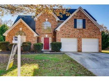 Brick house with two-car garage and landscaping at 726 White Dove Dr, Mcdonough, GA 30253