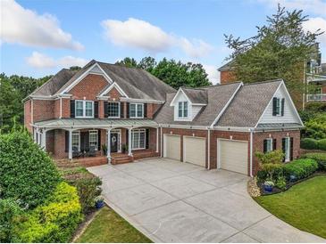 Brick house with three-car garage and landscaped yard at 131 Gold Springs Ct, Canton, GA 30114