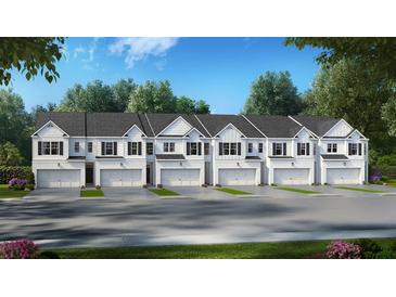 Exterior view of five townhomes with attached garages and landscaping at 305 Sound Cir, Stockbridge, GA 30281