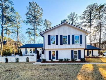 Two-story house with white siding, black shutters, and a landscaped yard at 110 Randomwood Way, Alpharetta, GA 30022