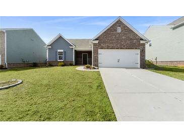 Charming single-Gathering home featuring a brick facade and a well-maintained front lawn at 3745 Newbury Place Dr, Loganville, GA 30052