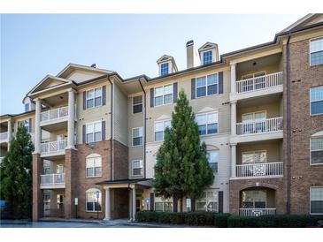 Exterior view of condo building with brick accents, neutral siding, and multiple balconies at 4805 West Village Way # 3207, Smyrna, GA 30080