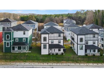 Street view of new construction homes with black fence and front yards at 679 Mcwilliams Se Rd, Atlanta, GA 30315