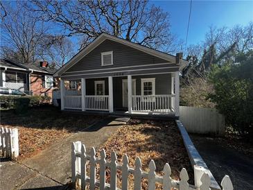 Gray house with white porch and picket fence at 1056 Welch Sw St, Atlanta, GA 30310
