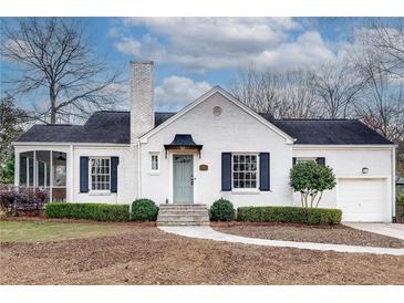 Charming white brick home featuring well-manicured landscaping and a covered porch, adding to its curb appeal at 332 Shadowmoor Dr, Decatur, GA 30030