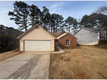 Ranch home with brick and vinyl siding, attached garage, and a spacious yard at 754 Shore Dr, Lithonia, GA 30058