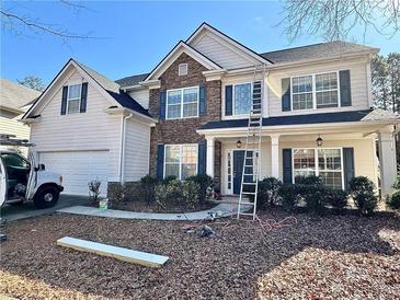 Charming two-story home featuring a stone facade, neutral siding, and well-maintained landscaping at 7972 Applemist Dr, Fairburn, GA 30213