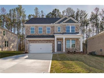 Charming two-story brick home featuring an attached two-car garage and well-maintained landscaping at 628 Leafy Branch Way, Mcdonough, GA 30253