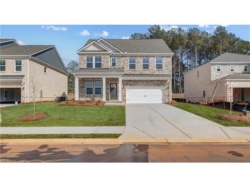 Charming brick two-story home with a two-car garage and well-manicured front lawn at 628 Leafy Branch Way, Mcdonough, GA 30253