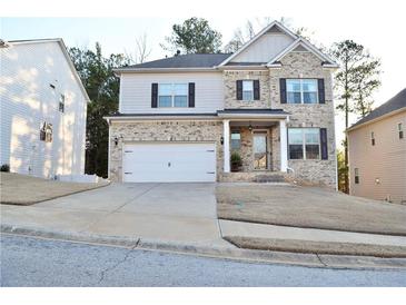 Charming two-story home with a brick facade, attached two-car garage, and well-manicured lawn at 2127 Dodson Woods Dr, Fairburn, GA 30213