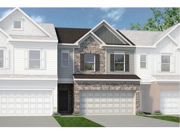 Two-story townhome with stone and siding exterior at 12 Jacobs Farm Ln # 6, Lawrenceville, GA 30043