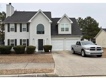 Two-story house with gray siding, attached garage, and manicured lawn at 331 Overlook Turn Northwest, Conyers, GA 30012