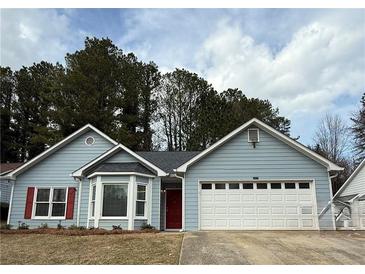 Charming single-story home with a two-car garage, red door and red shutters at 4815 Diggers Way, Sugar Hill, GA 30518